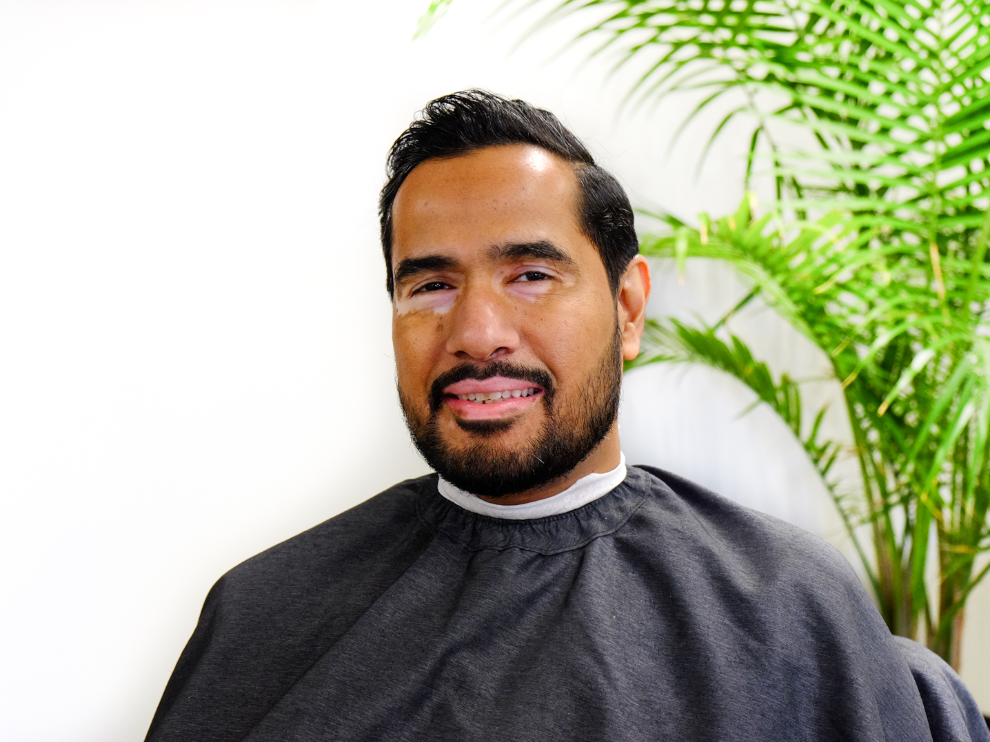Picture of a client after his haircut and beard trim inside the barbershop